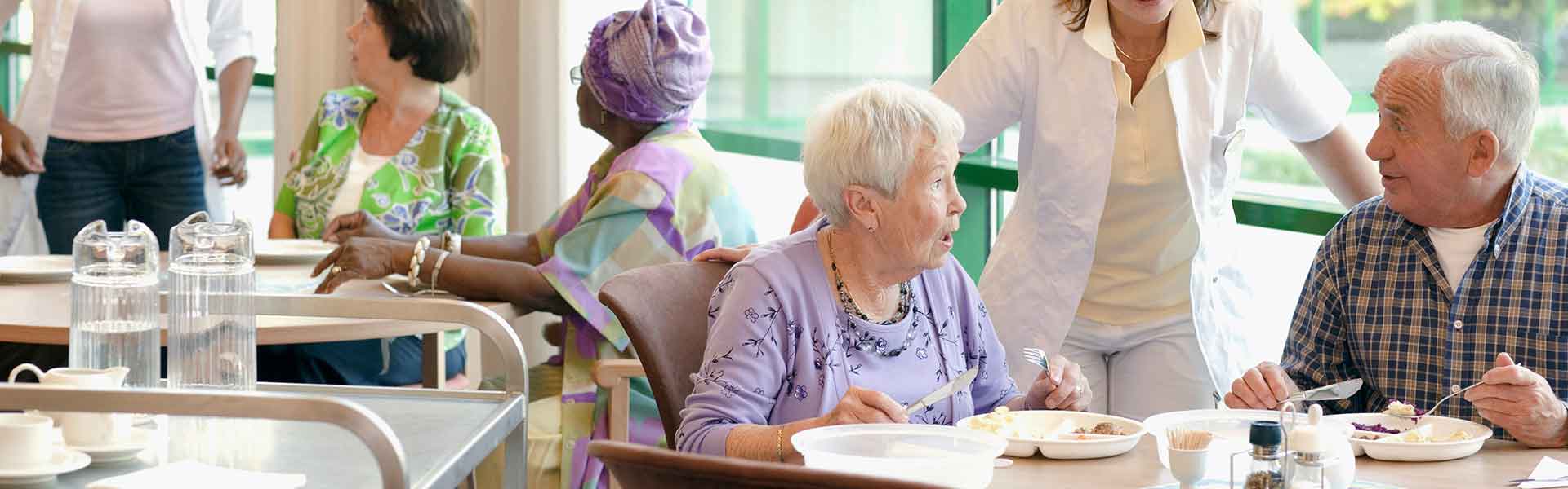 Elderly people eating in a care home